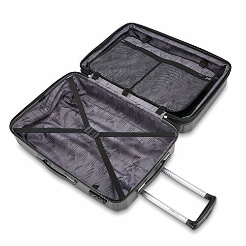 Open hard shell suitcase with internal compartments and straps